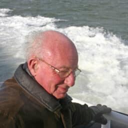 Man wearing a hearing aid on a boat.