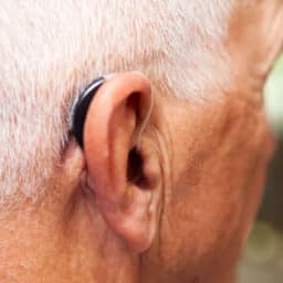 Senior man wearing a behind-the-ear hearing aid.