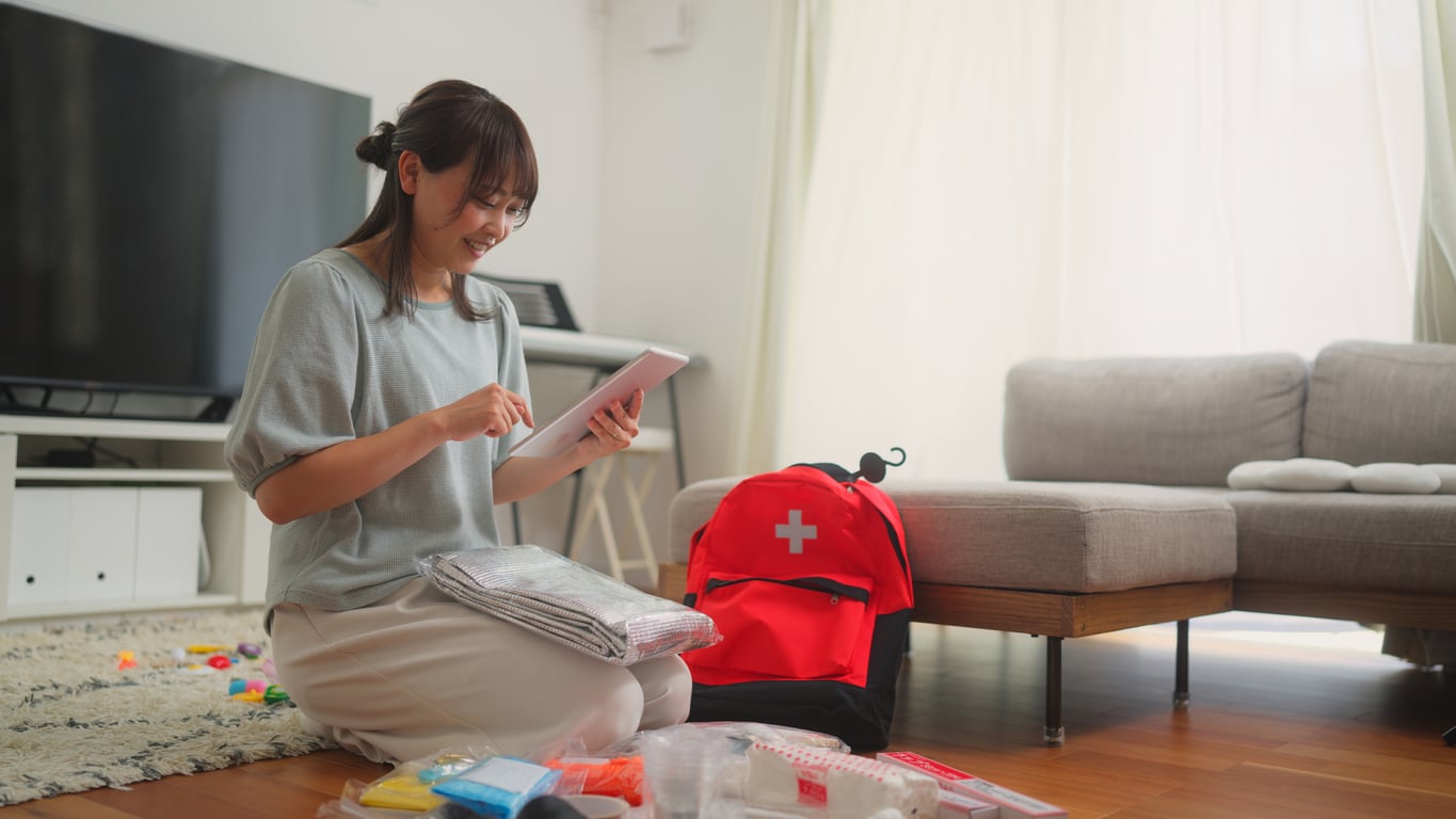 Woman preparing an emergency kit at home