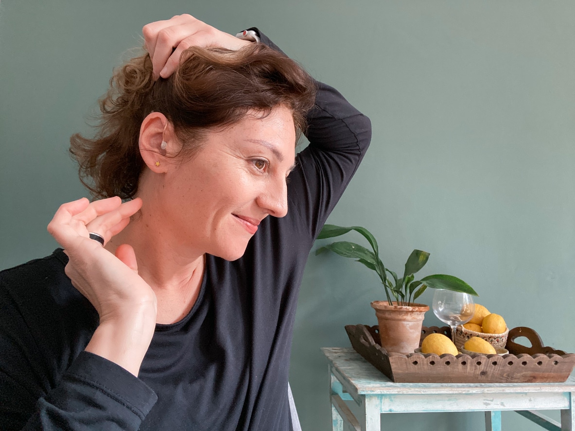 Happy woman admiring her new hearing aid